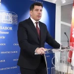 Nikola Grmoja u crnom odijelu za govornicom u Hrvatskom Saboru.