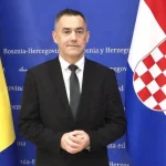 Tihomir Šarac, glasnogovornik HSP BiH ispred zastava R. Hrvatske i BiH.